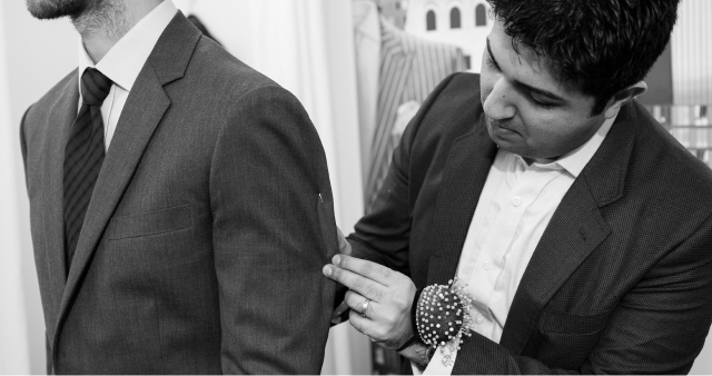 Tailor adjusting a jacket